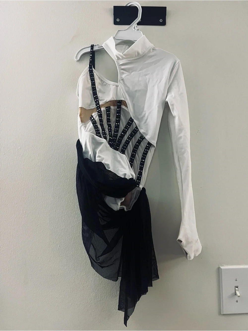 White and Black Asymmetric Dance leotard with Mesh Draping and cap.